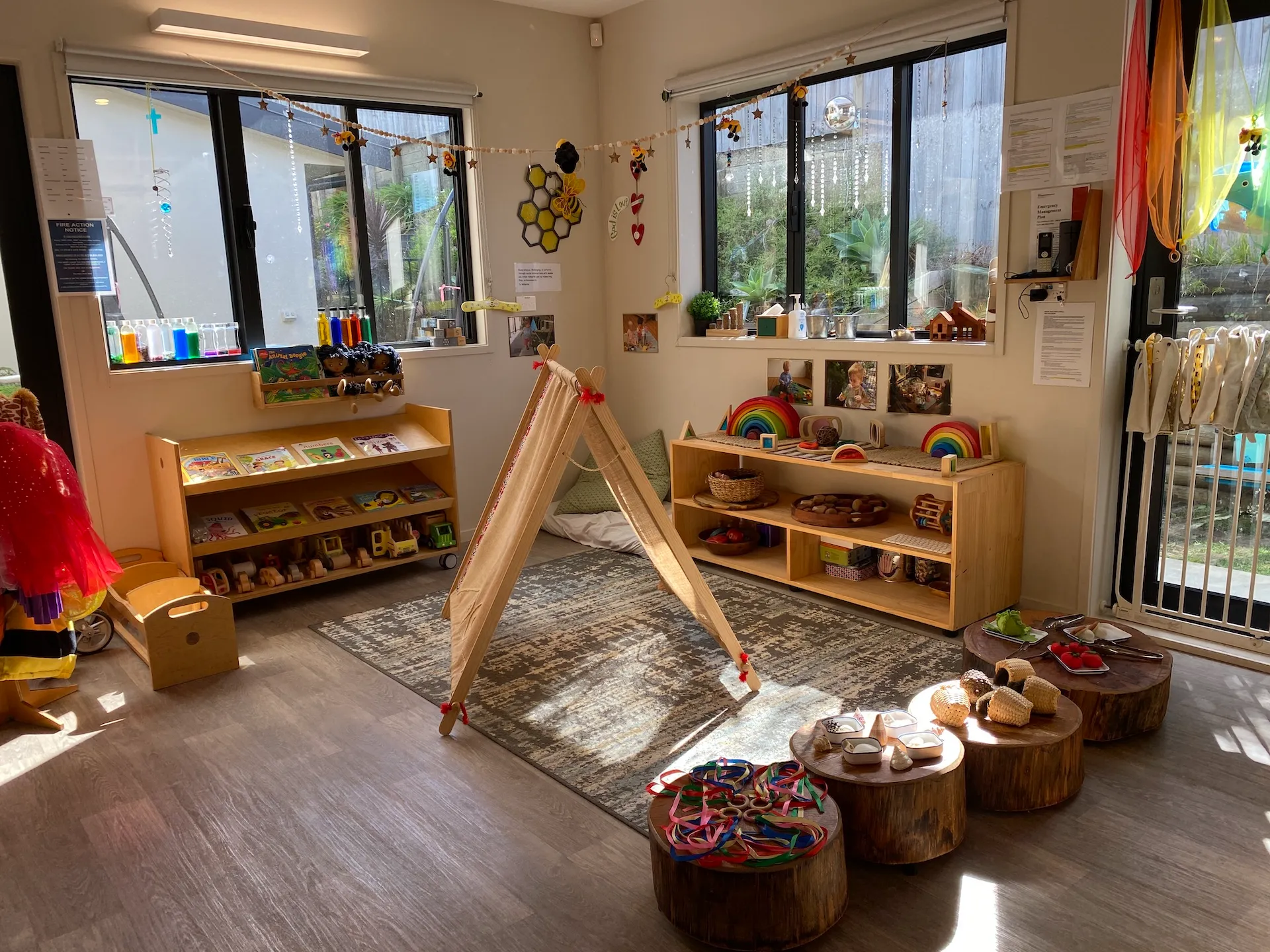 The Bee Room for under twos with wooden toys, a teepee and a cosy reading corner